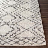 Close-up of the Mooroolbark Area Rug. Ivory shag rug with a gray geometric diamond pattern. Soft texture. Front