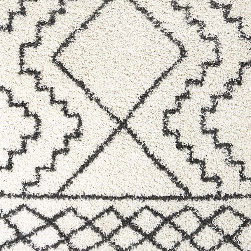 Close-up of the Mooroolbark Area Rug. Cream shag rug with a geometric diamond pattern in charcoal gray. Soft texture. Swatch
