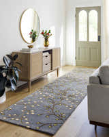 Hallway scene with Elsu Brown Beige Wool Rug runner, wood console table, mirror, and gray sofa. Roomscene-Runner