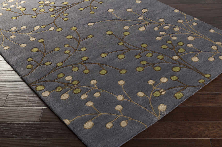 Close-up of the Elsu Brown Beige Wool Rug featuring a floral design with brown branches and beige and green buds. Corner