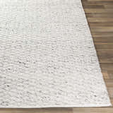 Close-up of the hand woven Martin Area Rug in black and ivory, showing texture and pattern. Front