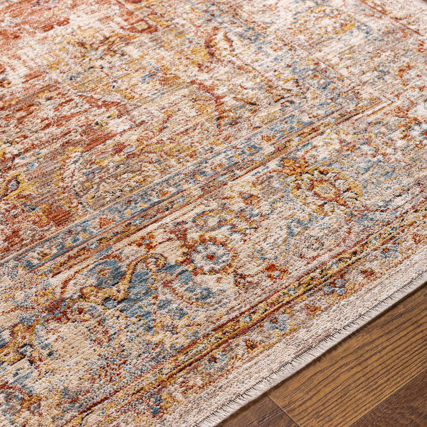 Close-up of the Marieville Luxe Performance Rug showing its traditional oriental pattern, brick red, cream, and blue colors. Texture