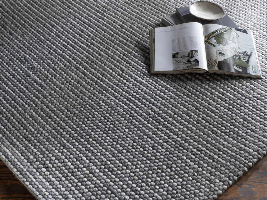 Close-up of the hand-woven Mulgoa Area Rug. Medium gray, contemporary style with a textured, looped design. Styleshot