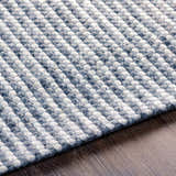 Close up of the hand woven Mulgoa Area Rug. Medium gray and white wool blend with a textured, contemporary design. Texture