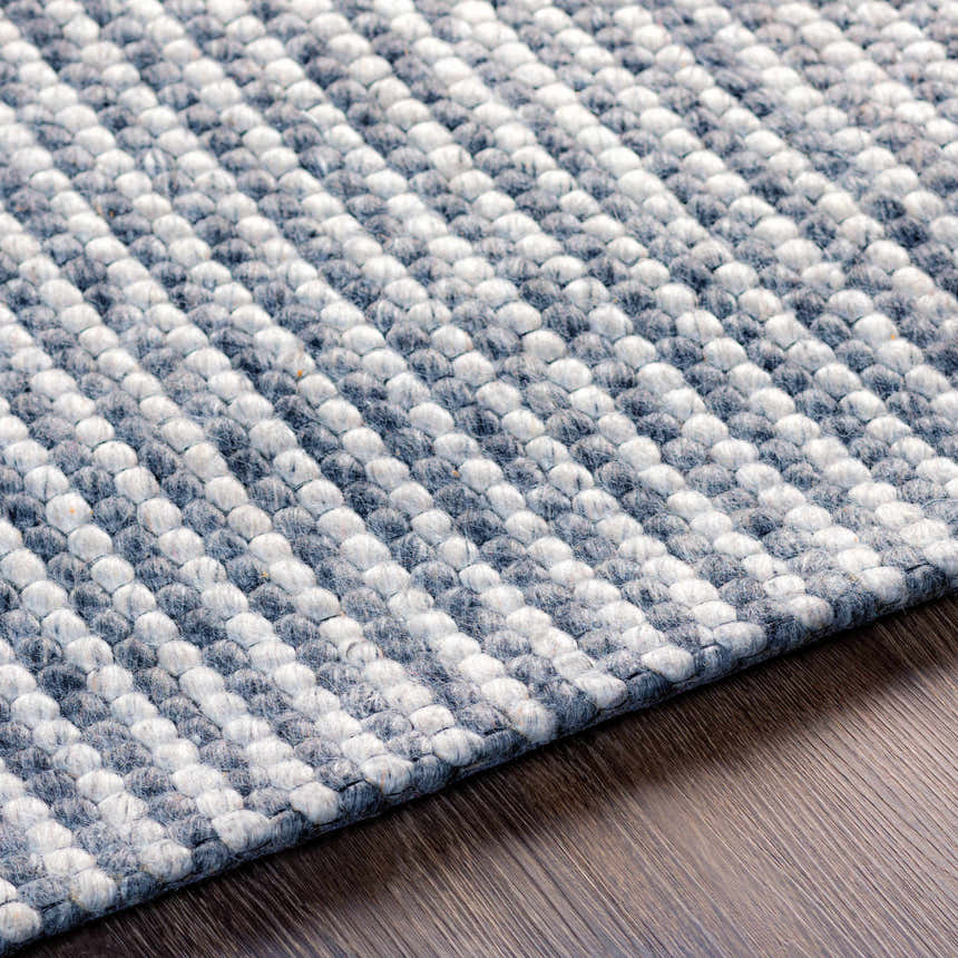 Close up of the hand woven Mulgoa Area Rug. Medium gray and white wool blend with a textured, contemporary design. Texture