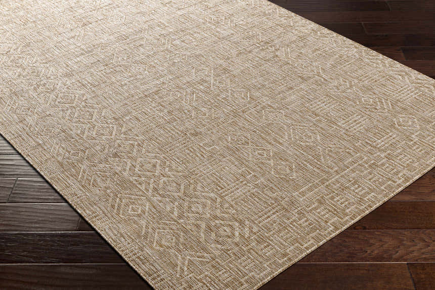 Close-up of the Epson Dark Beige Indoor & Outdoor Area Rug showing its woven texture and geometric pattern on dark wood floor. Corner