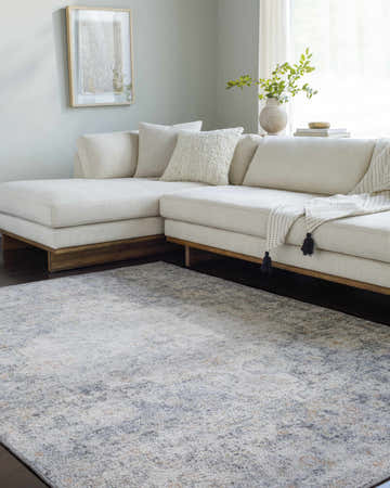 Living room scene with cream sectional sofa and gray, peach, and blue Wills Area Rug. Roomscene-Rectangle