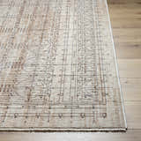 Close-up of the Neena Area Rug showing a geometric pattern in dark red, gray, and white on a wood floor. Front