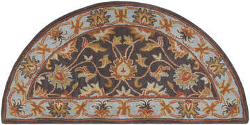 Close-up of the hearth-shaped Cherryfield 1004 rug. Hand-tufted wool rug in beige, burnt orange, and slate blue floral pattern. Design-Hearth
