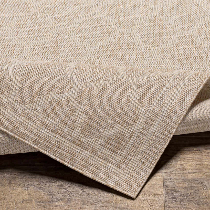 Close-up of the Noam Tan Indoor & Outdoor Rug showing the woven texture and subtle geometric pattern. Fold