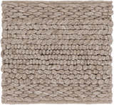 Close-up of the Newfolden Area Carpet. Hand-woven wool rug in brown, charcoal, and ivory with a chunky, textured design. Texture