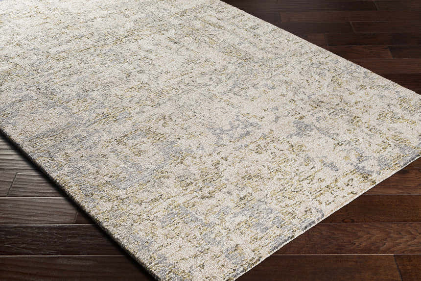 Close-up of the Namboongan Area Rug showing its cream, gray, and mustard abstract pattern and hand-tufted wool texture. Corner