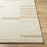 Close up of the hand tufted Nadav Beige Area Rug showing the wool texture and tan geometric pattern. Front