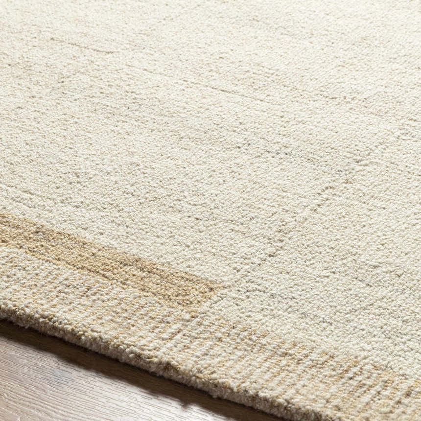Close-up of the hand-tufted Nadav Beige Area Rug, showing its ivory and tan wool texture and subtle stripe design. Texture
