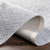 Close-up of the Boxholm Gray Hand Tufted Wool-Blend Rug showing its textured pattern and charcoal and light gray colors. Fold