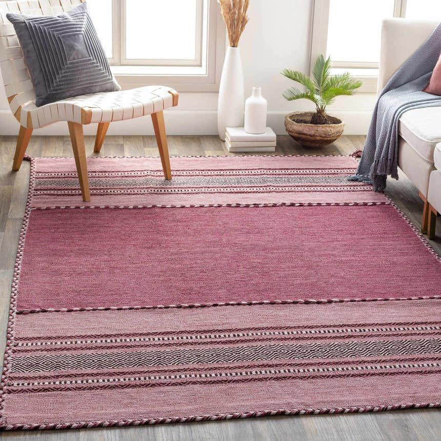 Living room scene with pink Northorpe Area Rug, white chair, and sofa. Farmhouse style with natural light. Roomscene-Rectangle