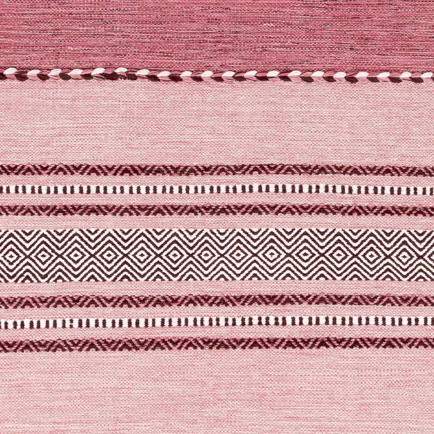Close-up of the hand woven Northorpe Area Rug. Burgundy, pink, and white geometric pattern on cotton. Farmhouse style. Swatch