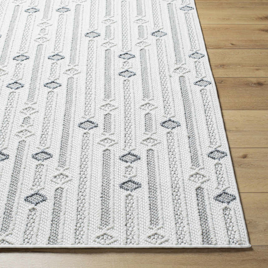 Close-up of the Niara Area Rug. Ivory rug with light and medium gray vertical stripes and diamond pattern. Front