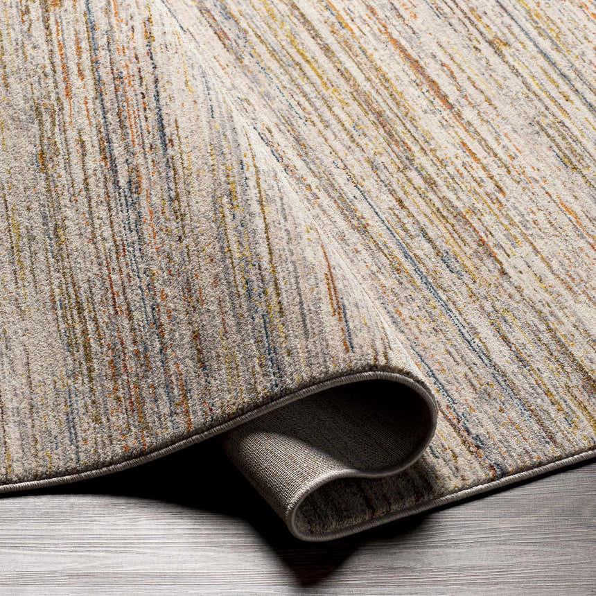 Close-up of the Nyeri Area Rug, showcasing its cream base with brick red, orange, blue, and gray vertical stripes. Fold