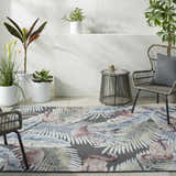 Coastal patio with Nayan Charcoal Area Rug. Features a flamingo and palm leaf pattern in blue, cream, and rust. Roomscene-Rectangle