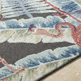 Close-up of Nayan Charcoal Area Rug showing coastal design, blue, cream, and rust colors, and soft polypropylene texture. Texture