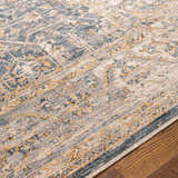 Close-up of the Odala Luxe Performance Rug. Bohemian style rug in denim, wheat, and cream colors. Texture
