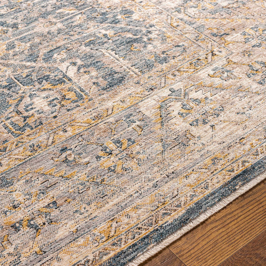 Close-up of the Odala Luxe Performance Rug. Bohemian style rug in denim, wheat, and cream colors. Texture