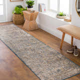 Entryway with an Odala Luxe Performance Rug runner in beige, blue, and gold tones. Bench, wood floors, and plants complete the scene. Roomscene-Runner