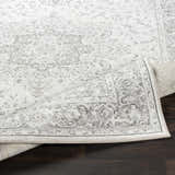Close-up of the Okehampton Area Rug, a farmhouse-style runner in charcoal, light gray, and white, on dark wood flooring. Fold