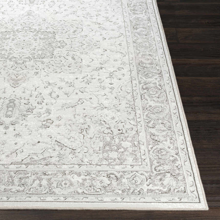Close-up of the Okehampton Area Rug. Farmhouse style rug in charcoal, light gray, and white with a traditional pattern. Front