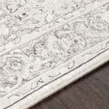 Close up of the Okehampton Area Rug, a farmhouse style rug in charcoal, light gray, and white. Texture