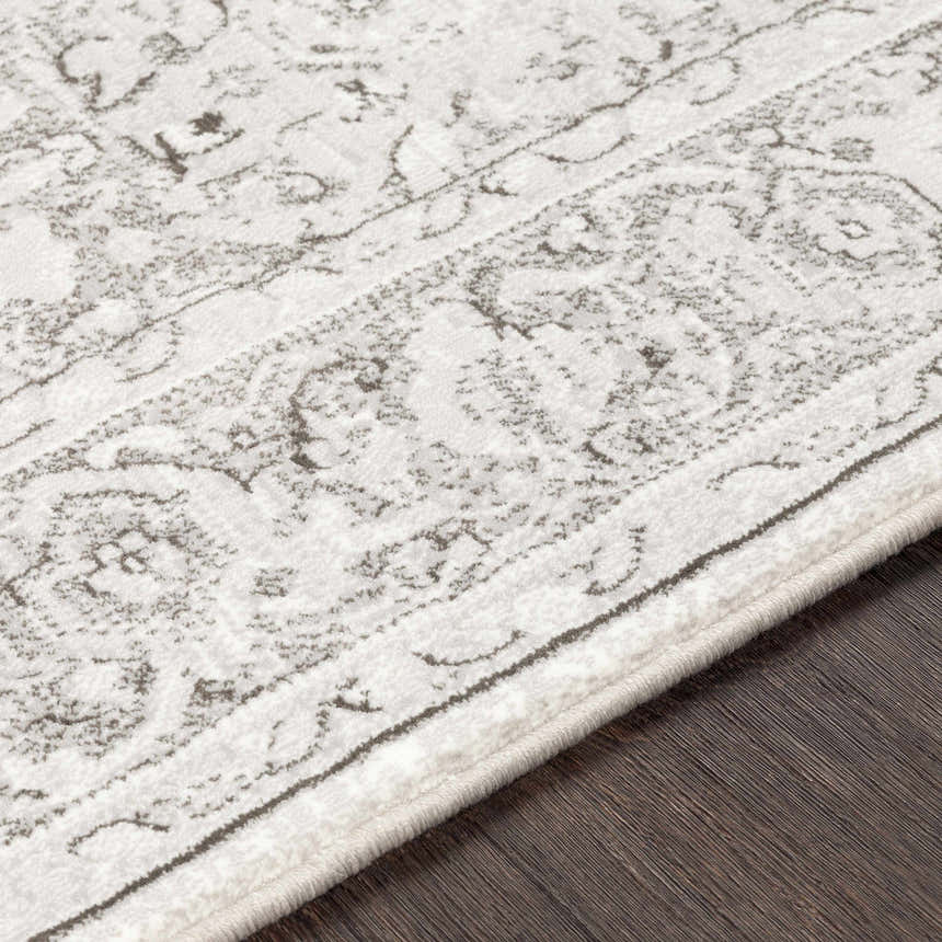 Close up of the Okehampton Area Rug, a farmhouse style rug in charcoal, light gray, and white. Texture