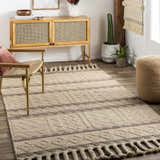 Living room scene with tan Okurcalar Area Carpet, woven chair, and wood cabinet. Bohemian style with jute and wool textures. Roomscene-Rectangle