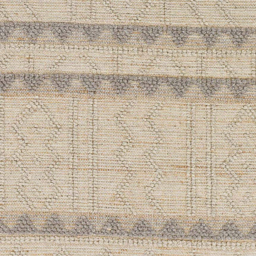 Close-up of Okurcalar Area Carpet. Hand-woven jute and wool rug with gray geometric patterns on a tan background. Swatch