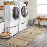 Bright laundry room with white washer and dryer, and tan Okurcalar Area Carpet runner with tassels. Roomscene-Runner