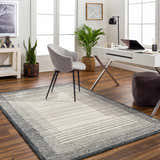 Home office with Omeo Wool Area Rug in bone and dark gray, gray chair, white desk, and wood floors. Roomscene-Rectangle