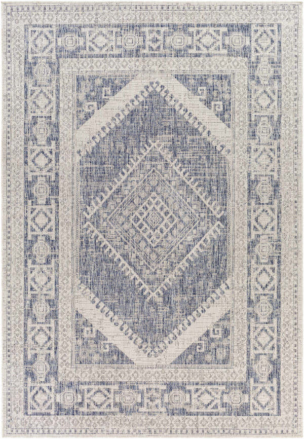 Close-up of the Umraniye Gray Area Rug. Features a geometric, diamond pattern in shades of blue, gray, and off-white. Design-Rectangle-537