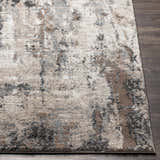 Close up of the Opunake Luxe Thick Area Rug showing its abstract pattern and colors: cream, gray, brown, and black. Front