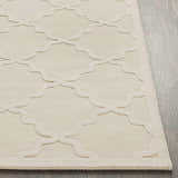 Close up of the beige Orick Hand Loomed Wool Area Rug featuring a raised quatrefoil pattern and textured weave. Front