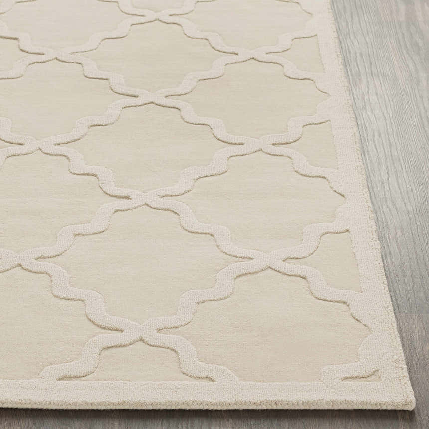 Close up of the beige Orick Hand Loomed Wool Area Rug featuring a raised quatrefoil pattern and textured weave. Front