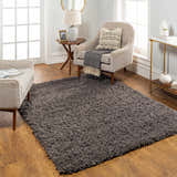 Living room scene with a Siari Solid Charcoal Shag Rug, neutral armchairs, and warm wood accents. Roomscene-Rectangle