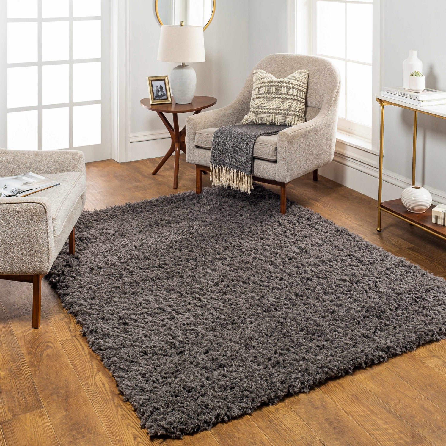 Living room scene with a Siari Solid Charcoal Shag Rug, neutral armchairs, and warm wood accents. Roomscene-Rectangle