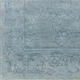 Close-up of the hand-knotted Oxly Area Rug. Farmhouse style rug in blue and sage with a traditional floral pattern. Swatch
