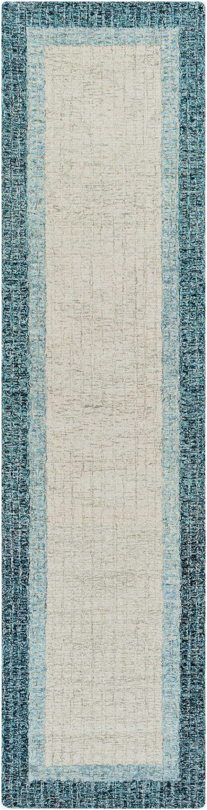 Close-up of the hand-tufted Padada Green Bordered Cream Wool Rug with teal, light blue, and cream colors. Design-Runner-2610