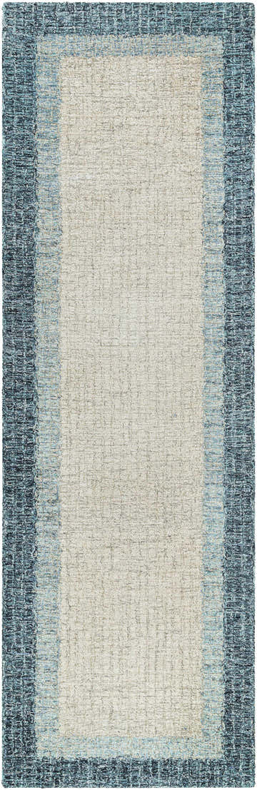 Close-up of the Padada Green Bordered Cream Wool Rug. Features a cream center and a blue, hand-tufted border. Design-Runner-268