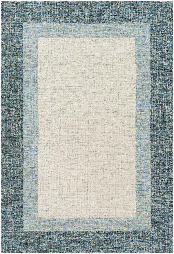 Close-up of the hand-tufted Padada Green Bordered Cream Wool Rug, featuring cream, light blue and navy hues. Design-Rectangle-576