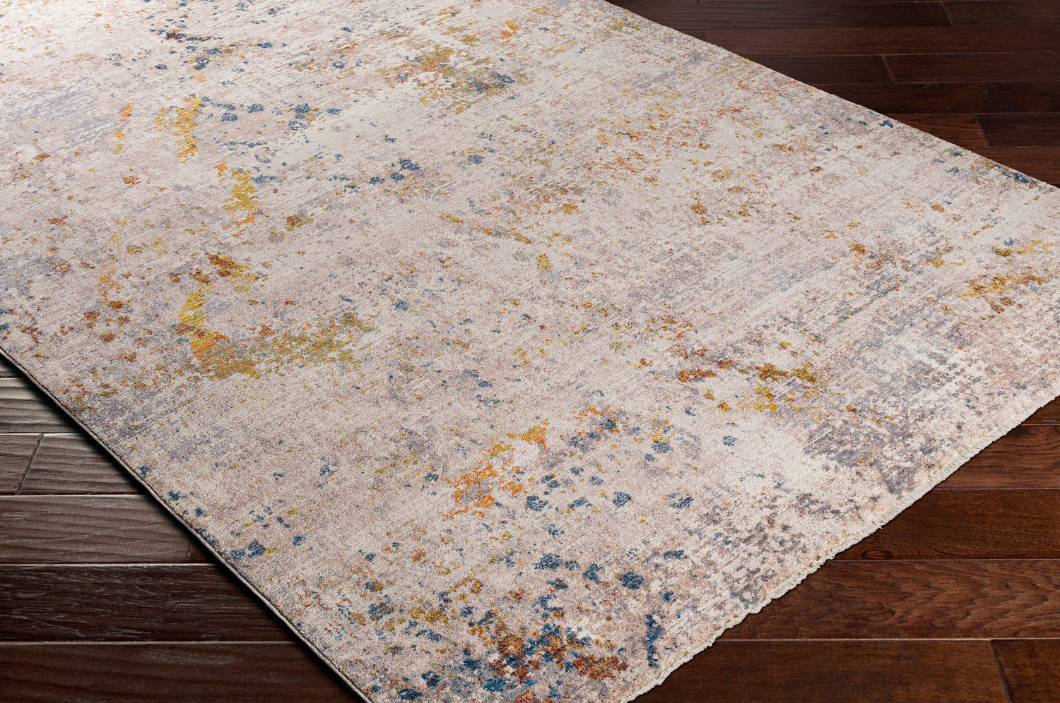 Close-up of Palhi Area Carpet. Cream rug with brick red, dark blue, mustard, and light beige abstract pattern. Corner