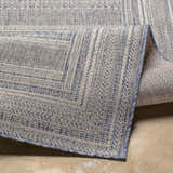 Close-up of the Panaytayon Area Rug showcasing its blue and cream woven pattern and textured edge. Fold