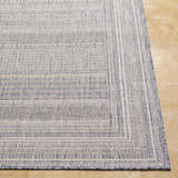 Close-up of the machine-woven Panaytayon Area Rug. Features a geometric pattern in cream, natural gray, and navy blue. Front