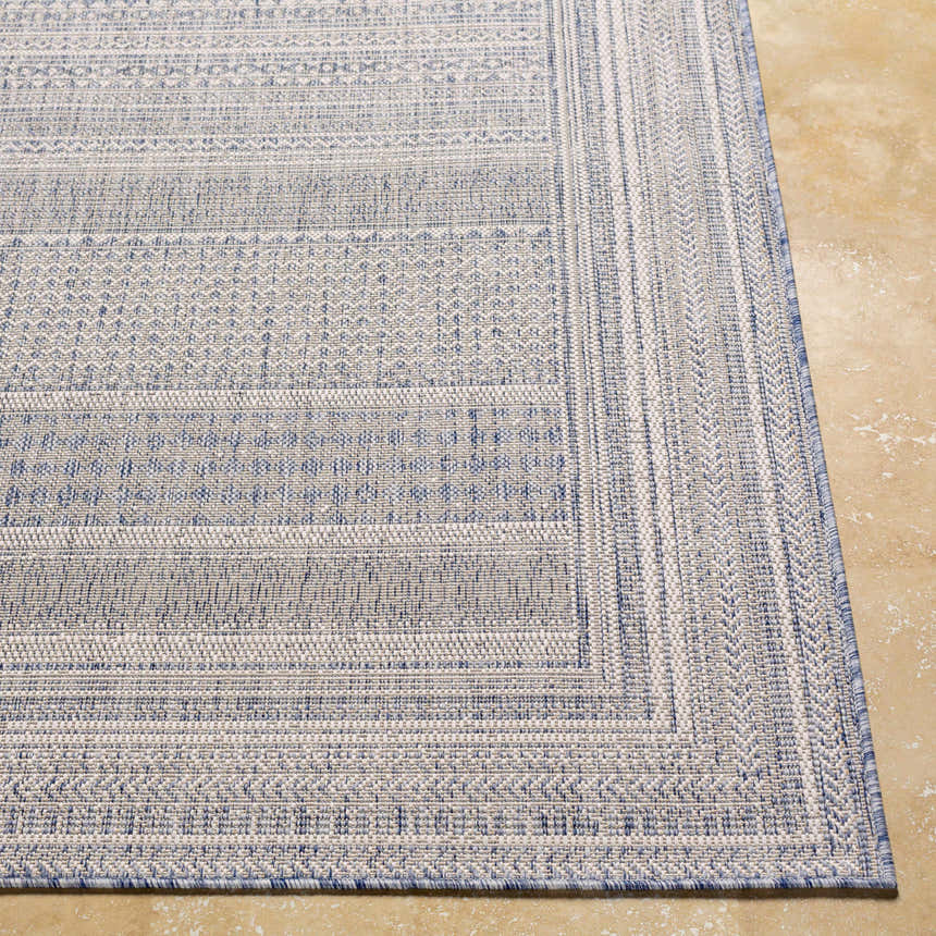 Close-up of the machine-woven Panaytayon Area Rug. Features a geometric pattern in cream, natural gray, and navy blue. Front